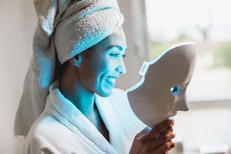 Woman using Glokore LED mask